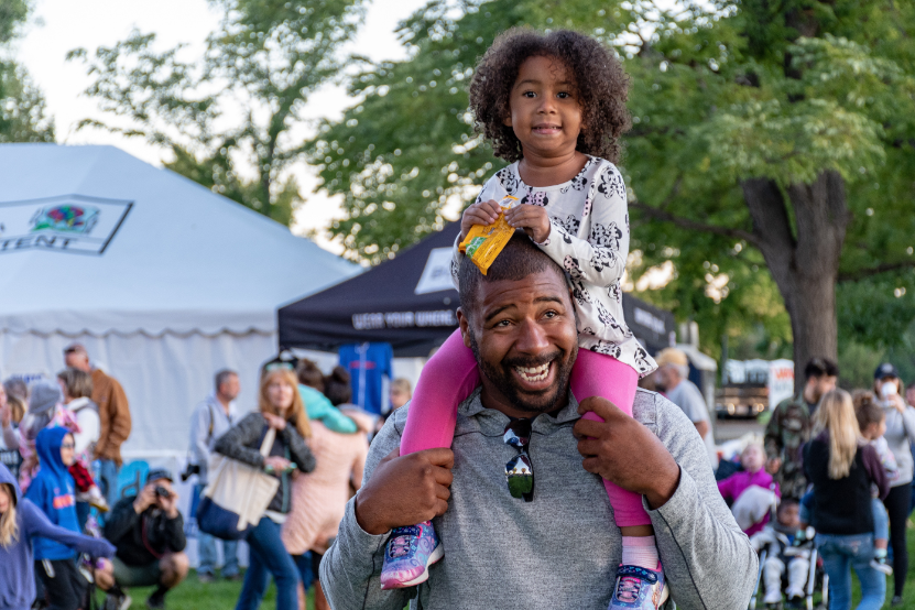 Child on mans shoulders